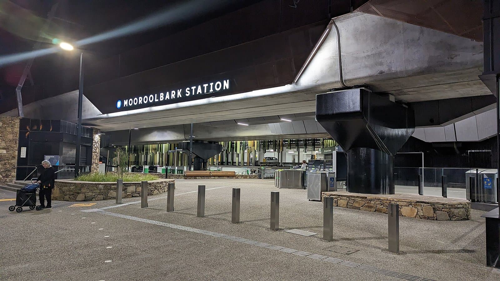 The front of Mooroolbark railway station, with its name on the canopy, at dusk
