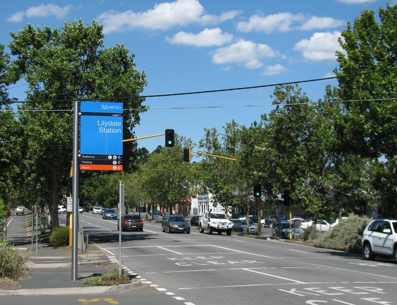 The Maroondah Highway through Lilydale, lined with street trees and parked cars